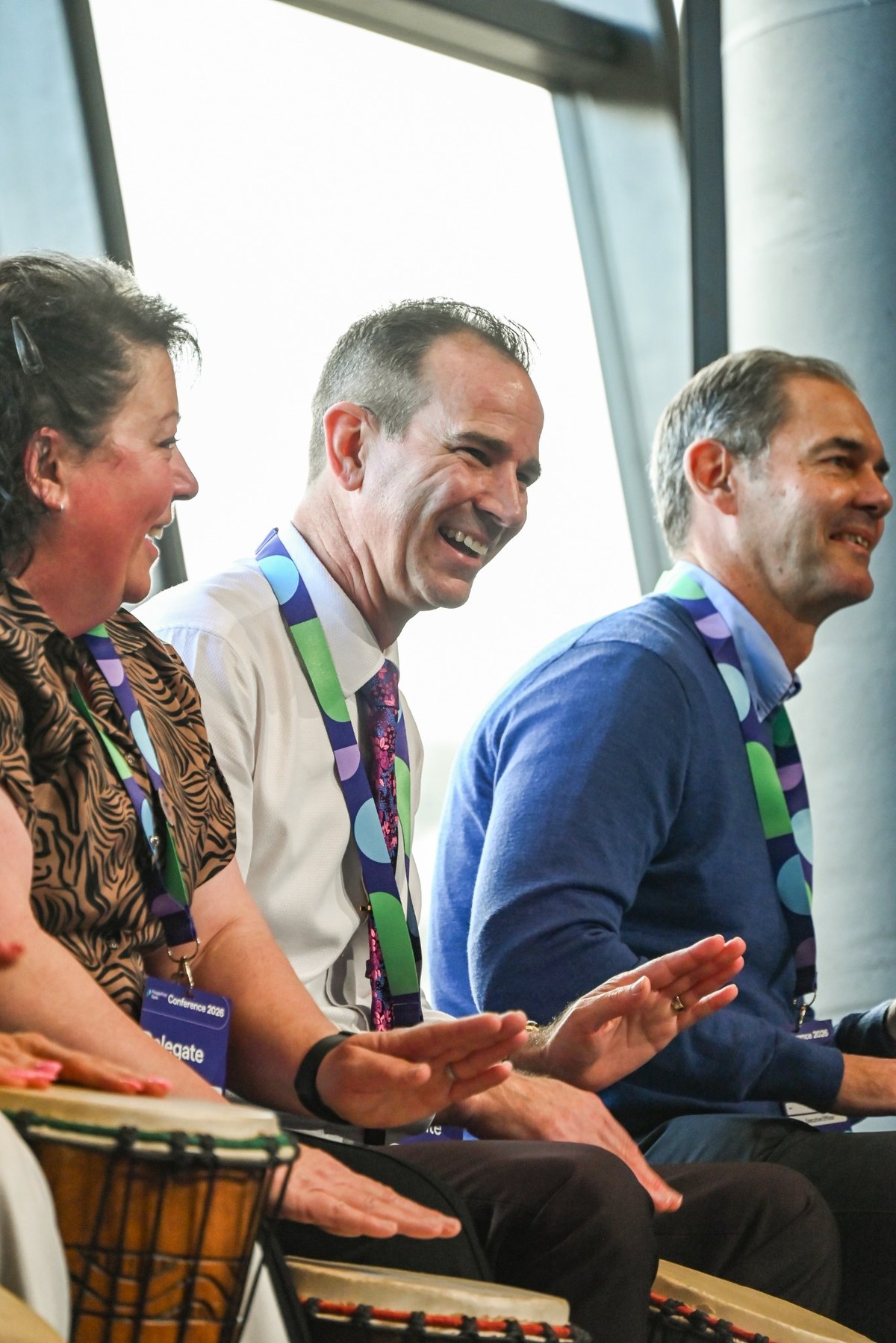 Conference delegates smiling and participating together during an InRhythm interactive rhythm experience