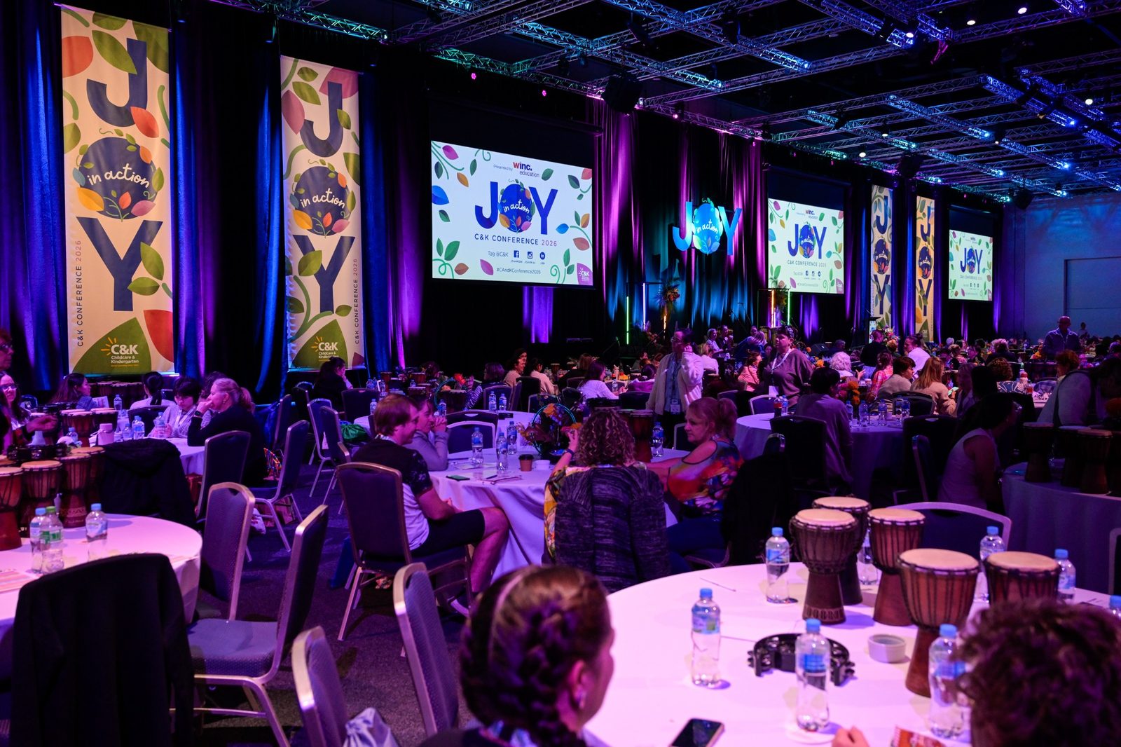 InRhythm facilitators leading a large conference rhythm experience