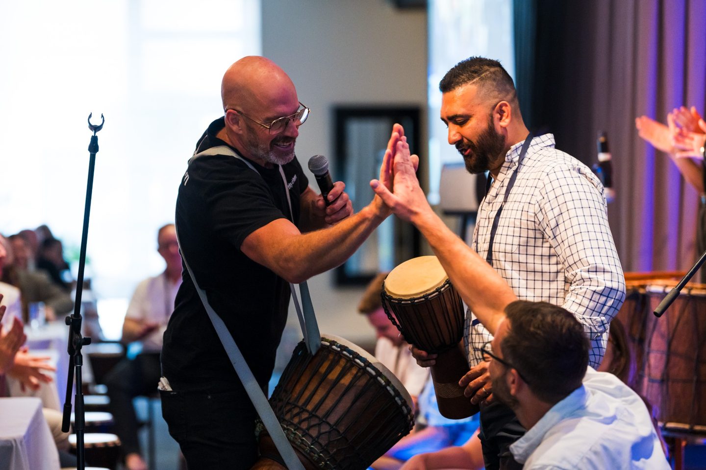 InRhythm facilitator connecting with a corporate participant during an interactive drumming session