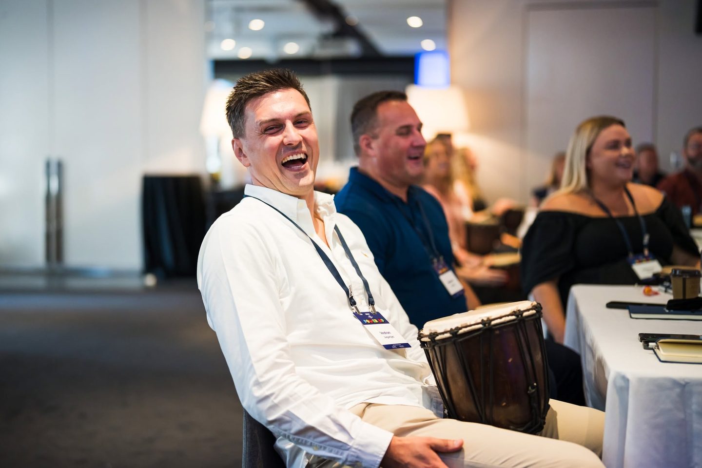 Corporate participant enjoying an interactive InRhythm team drumming experience