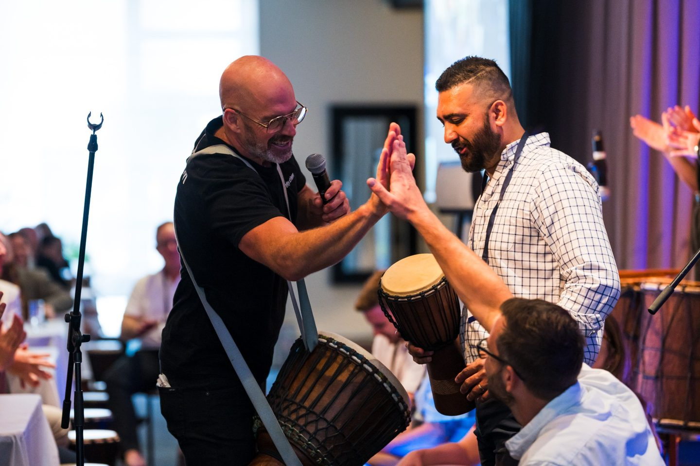 InRhythm facilitator connecting with a participant during an interactive group drumming experience