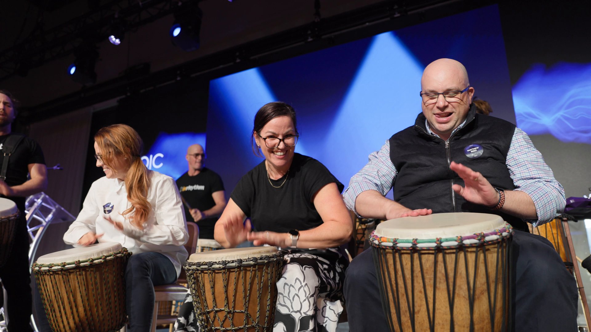 People enjoying an interactive InRhythm group drumming experience